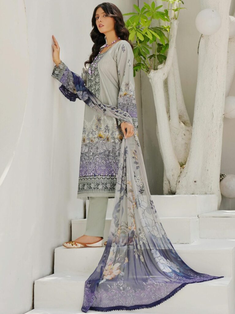 A woman poses in a beautiful traditional salwar kameez with a scarf, showcasing South Asian fashion in Lahore, Pakistan.
